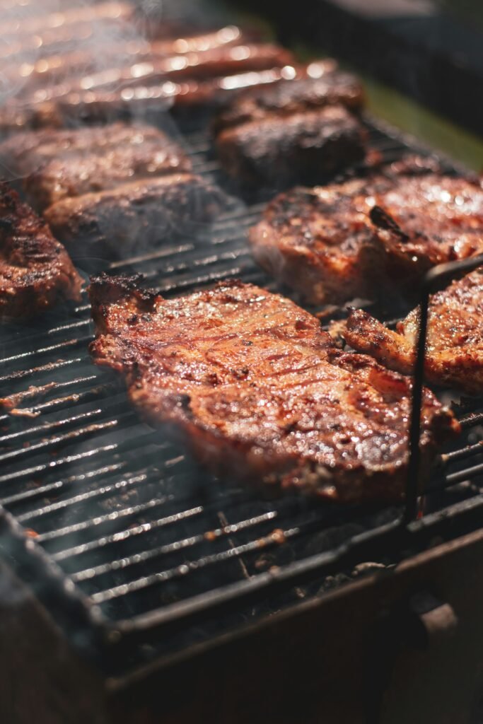 Steak on a charcoal grill grate